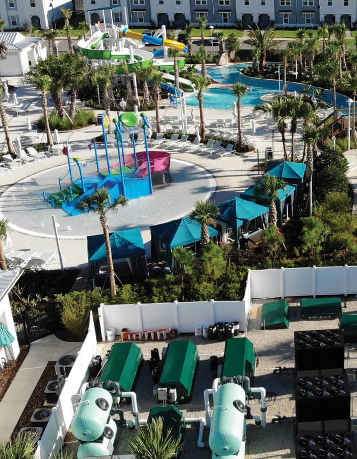 resort-style waterpark in a tropical setting featuring double flume waterslides and a water play structure