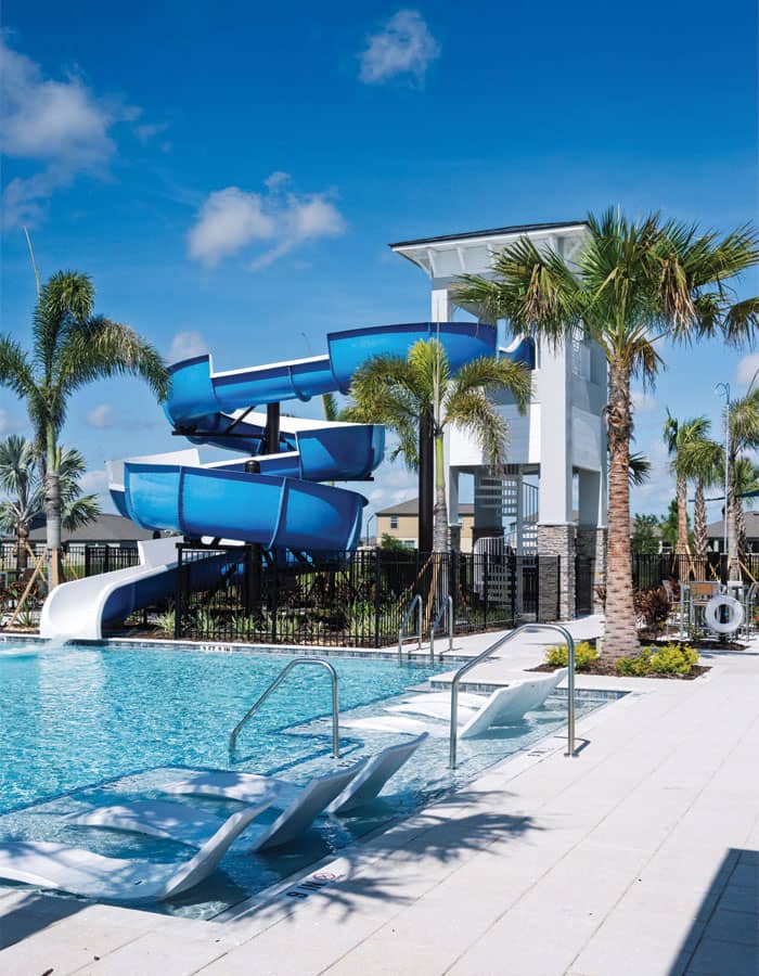 blue open flume waterslide in a tropical setting