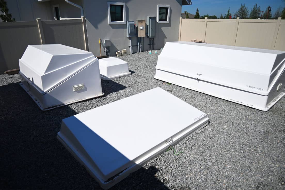 white filtration equipment packs in an outdoor equipment yard