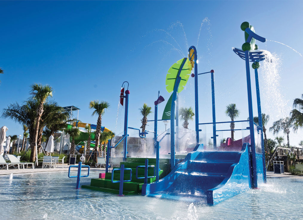 interactive water playset in a kiddie pool with a spraying palm leaf water feature