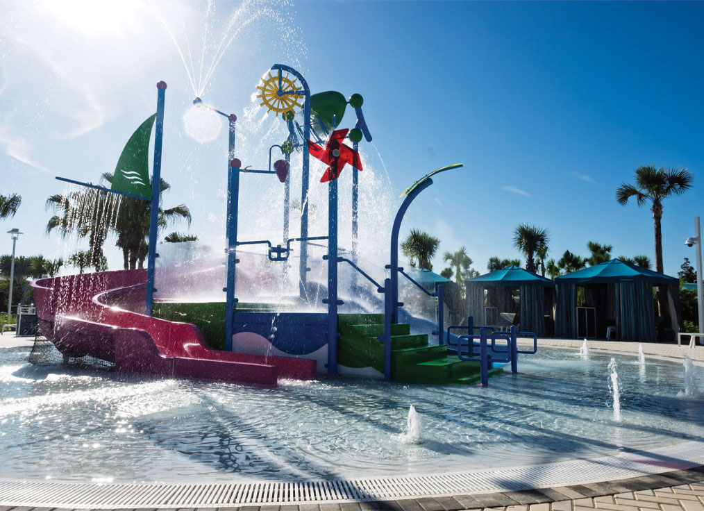interactive water playset in a kiddie pool with geyser jets, a large dumping bucket, and windmill water feature