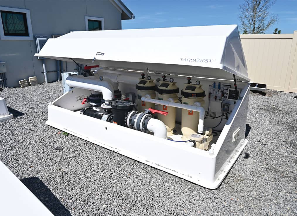 white swimming pool filtration equipment pack with pumps and filters