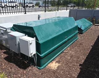 green filtration equipment packs that house the splash pad water management system are located in an outdoor equipment yard