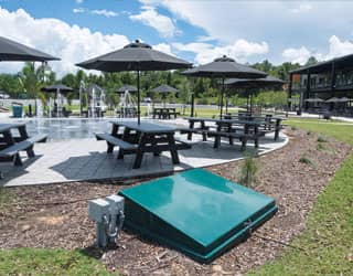subterranean collector tank is located adjacent to the splash pad