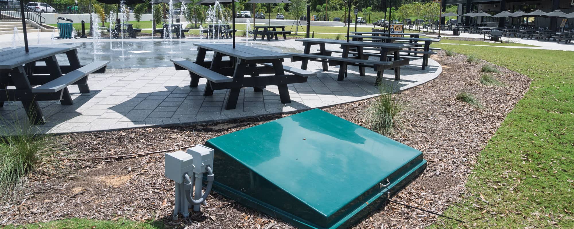 subterranean collector tank is located adjacent to the splash pad