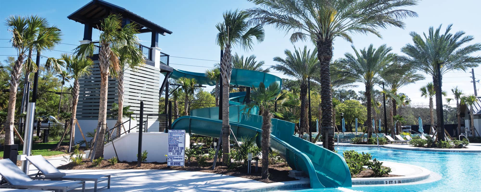 blue waterslide in a tropical setting