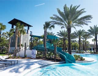 blue waterslides in a tropical setting