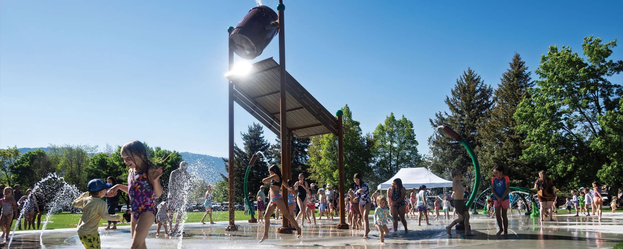 children frolicking on splash pad
