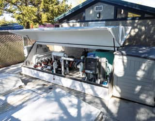 white, 14-foot filtration equipment pack that contains the recirculating filtration system for the splash pad