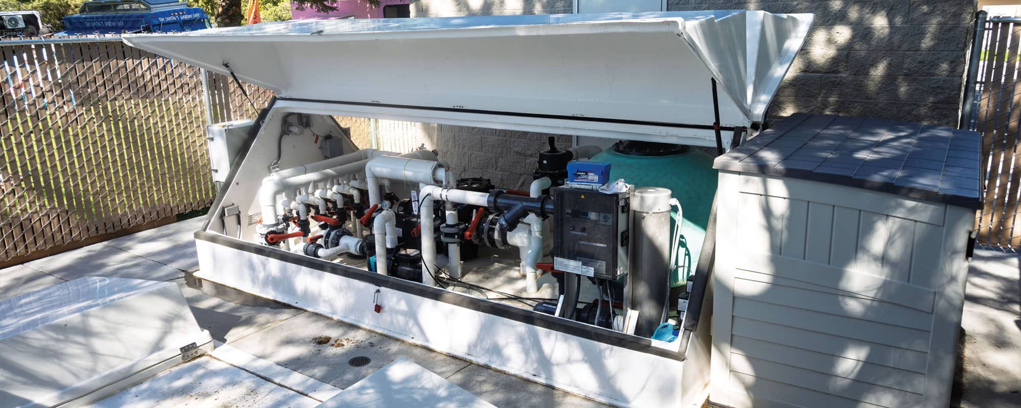 white, 14-foot filtration equipment pack that contains the recirculating filtration system for the splash pad