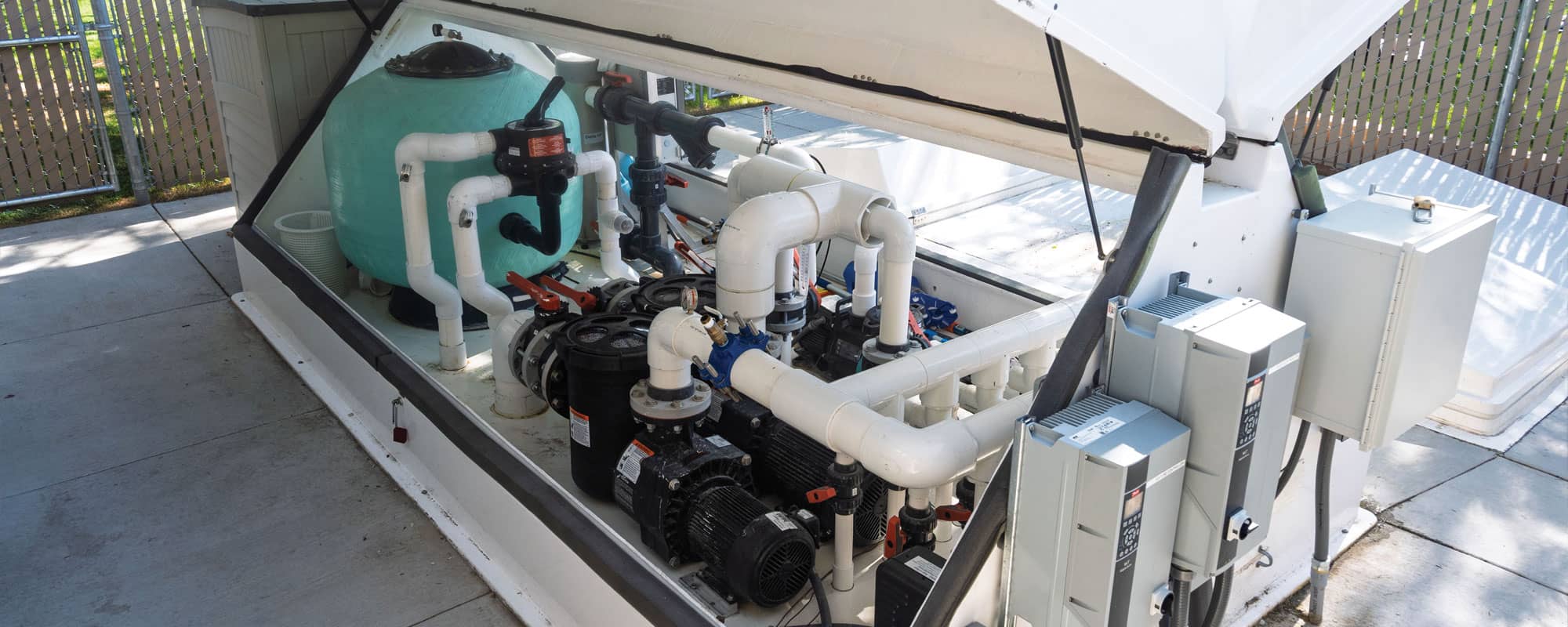 inside of the splash pads recirculating filtration system that shows sand filters and pumps