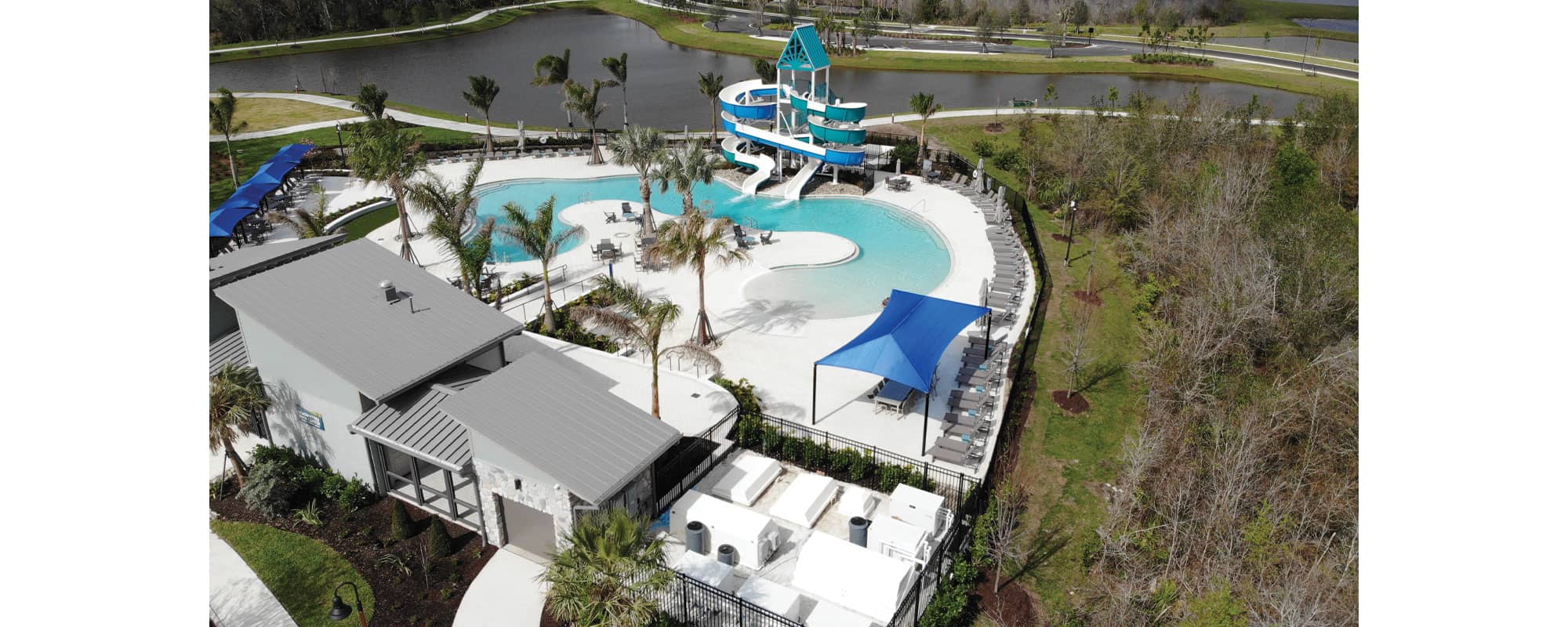 overhead view of swimming pool, double flume waterslide, and filtration equipment