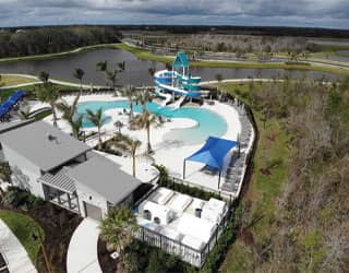 overhead view of swimming pool, double flume waterslide, and filtration equipment