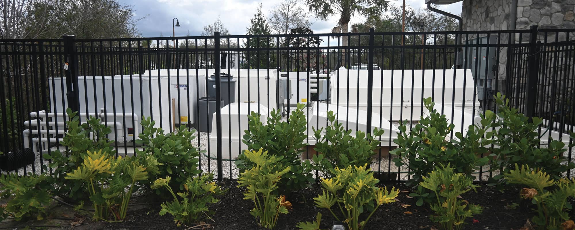 gated equipment yard with white filtration equipment packs