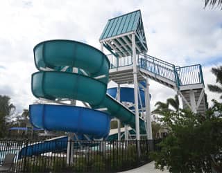 side view of open flume waterslide and custom steel staircase