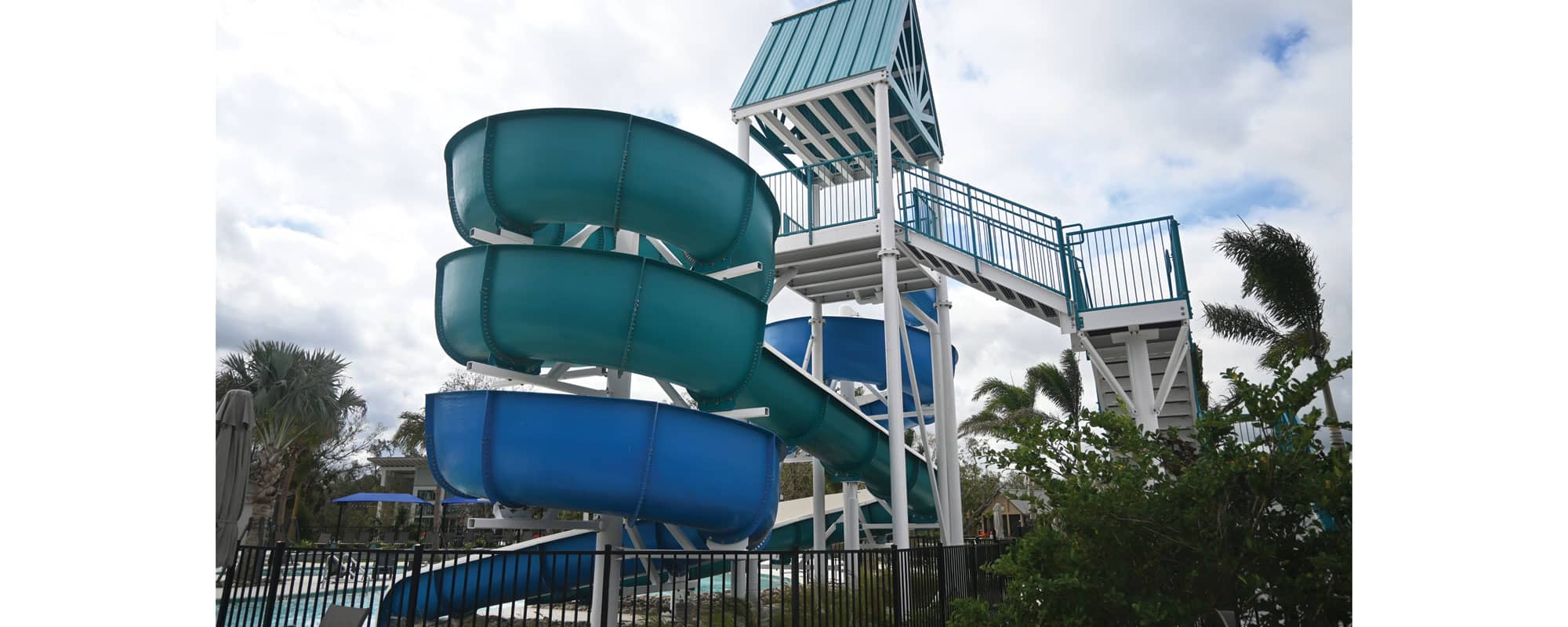 side view of open flume waterslide and custom steel staircase