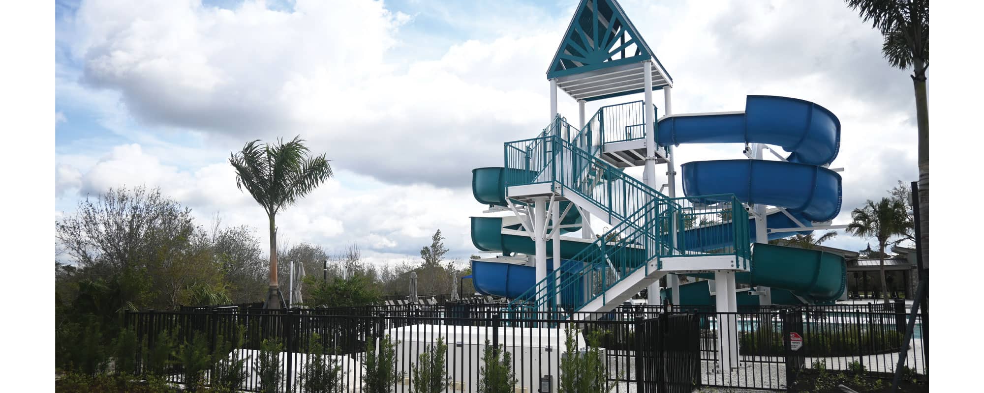 steel staircase for a double flume waterslide and white filtration equipment packs