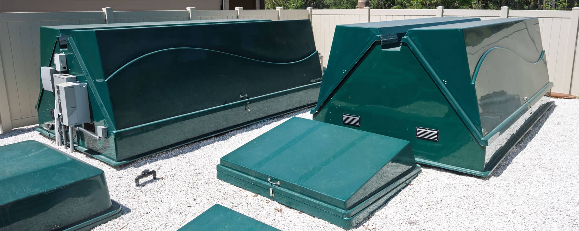 green equipment packs with a wave design in an outdoor equipment yard that is gated