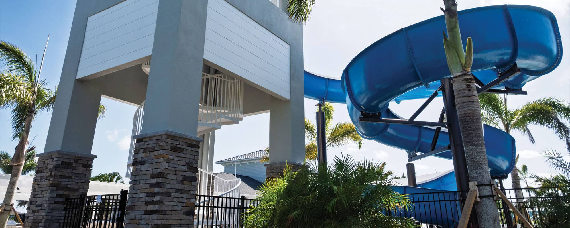back view of the waterslide structure that shows the spiral staircase concealed within a concrete structure