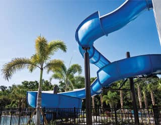 underside of the blue, open-flume water slide showing the waterslide support beams