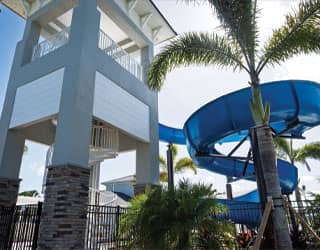 back view of the waterslide structure that shows the spiral staircase concealed within a concrete structure