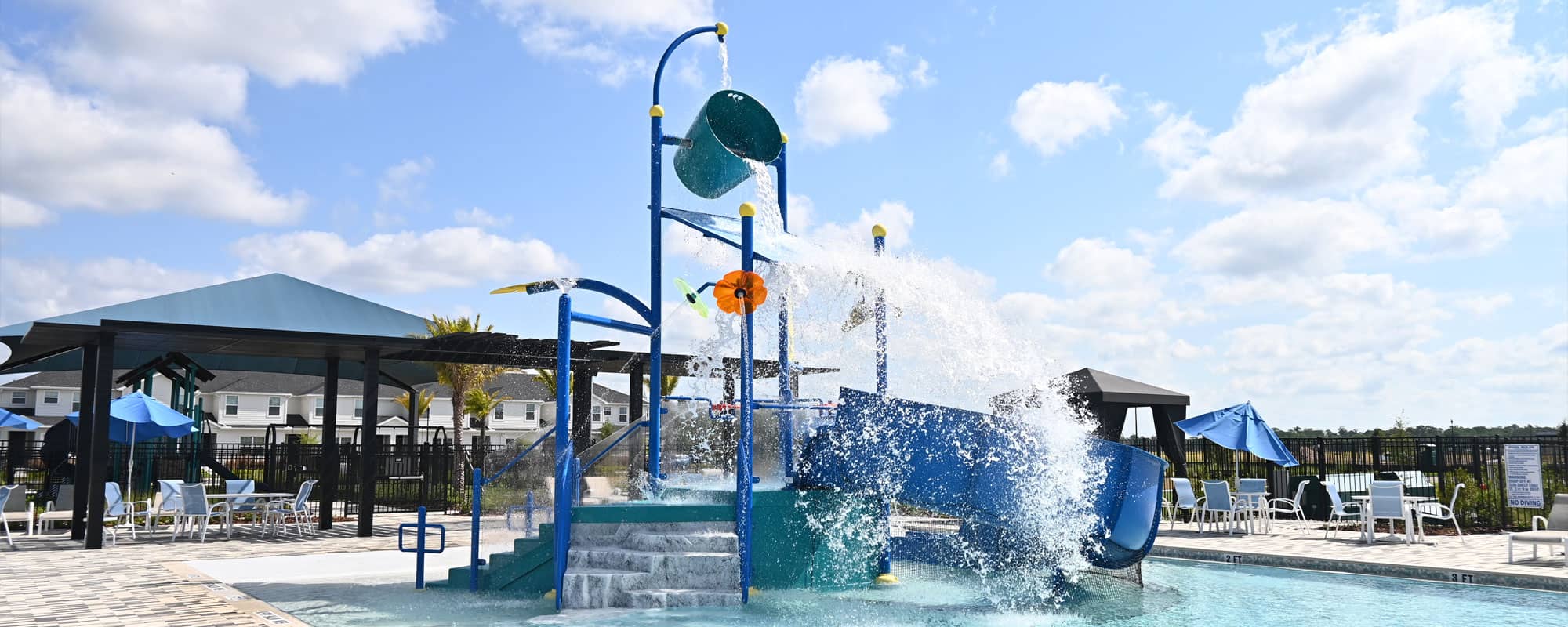 blue water playset with large dumping bucket in a swimming pool