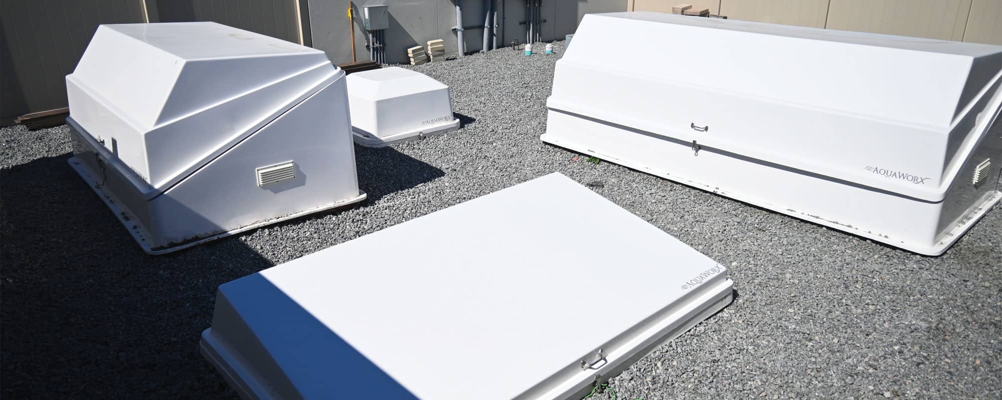equipment yard for swimming pool with white filtration equipment cabinets