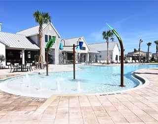 palm tree-themed interactive water features and dumping buckets in a beach-entry swimming pool