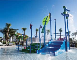 multi-level water playset with waterslide and interactive water features in a kiddie pool