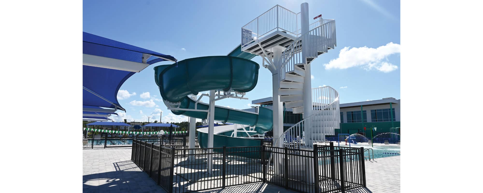 Open flume waterslide with spiral staircase tower