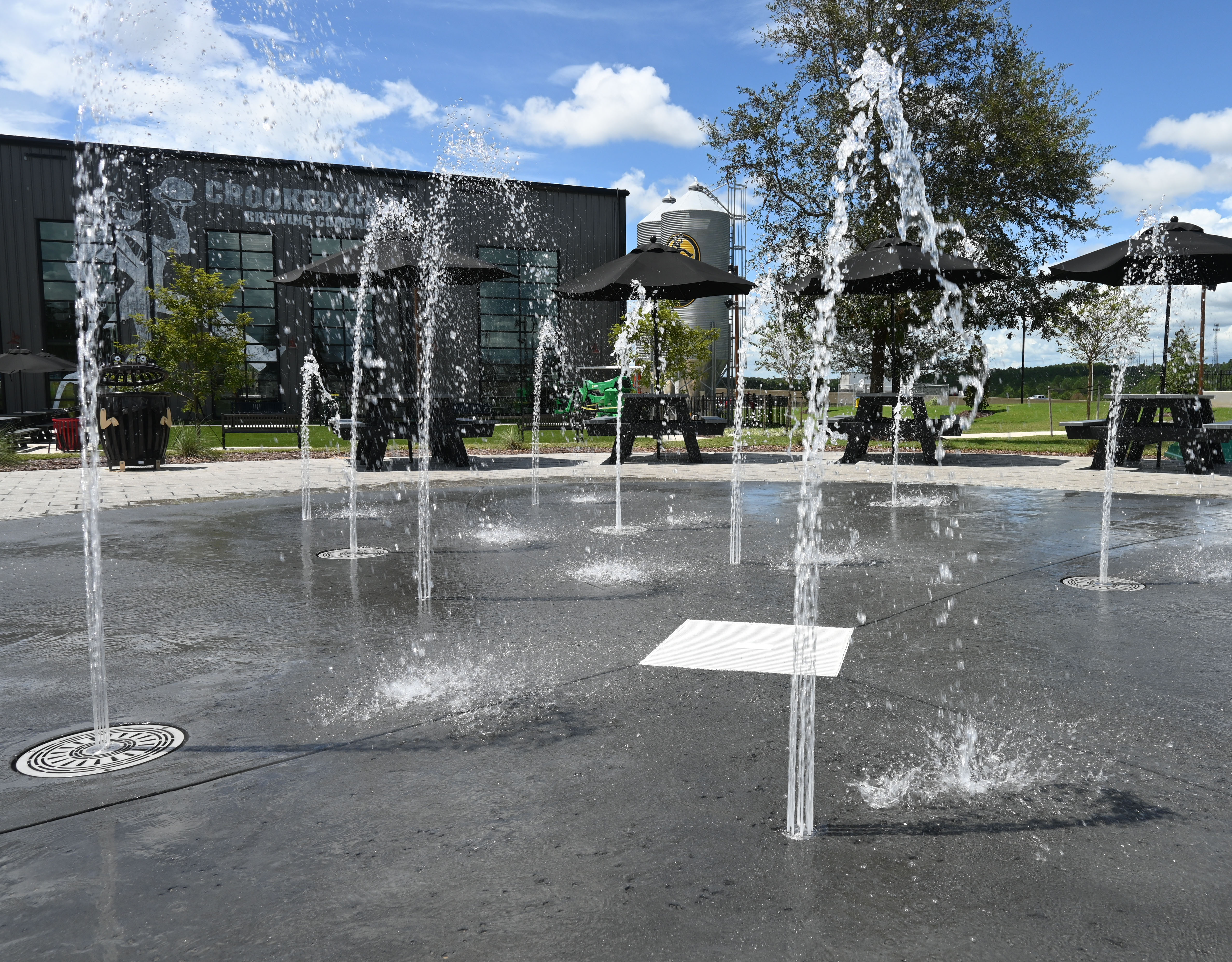 Close-up shot of Fountain in a Can and Aqua Cone ground sprays on splashground